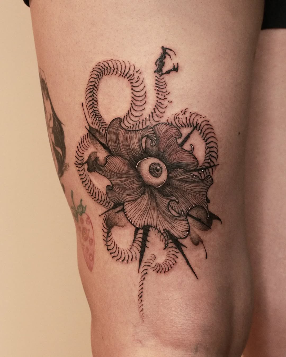 Intricate flower tattoo with an eye detail
