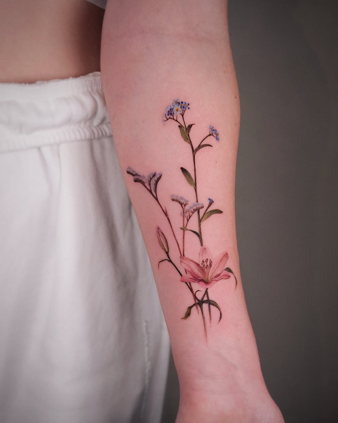 Elegant floral tattoo on the forearm
