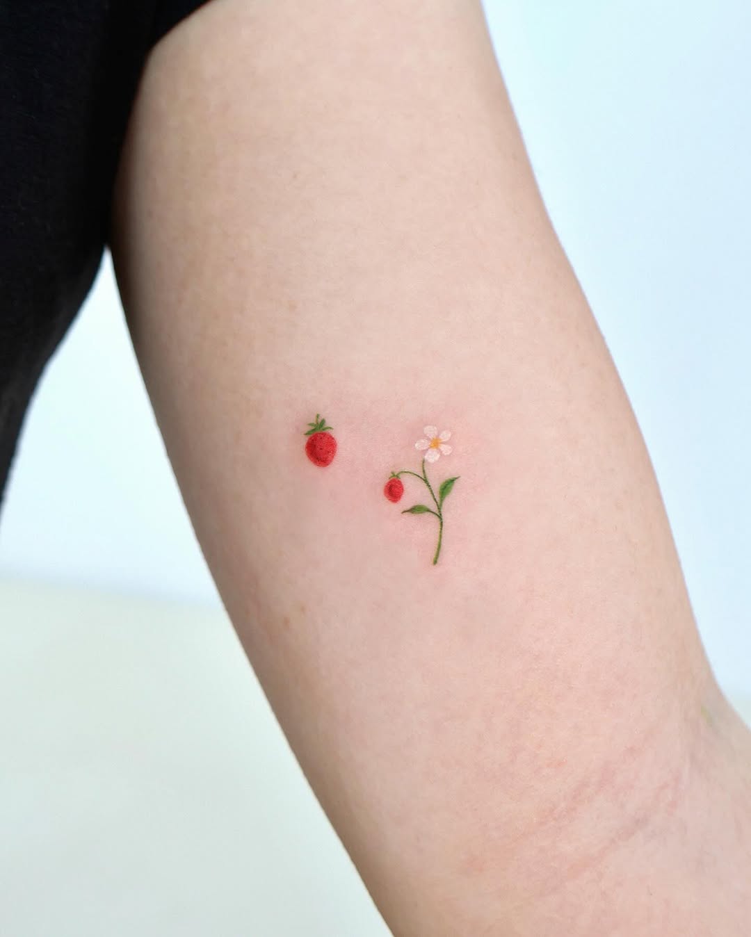 Charming strawberry and flower tattoo inspiration