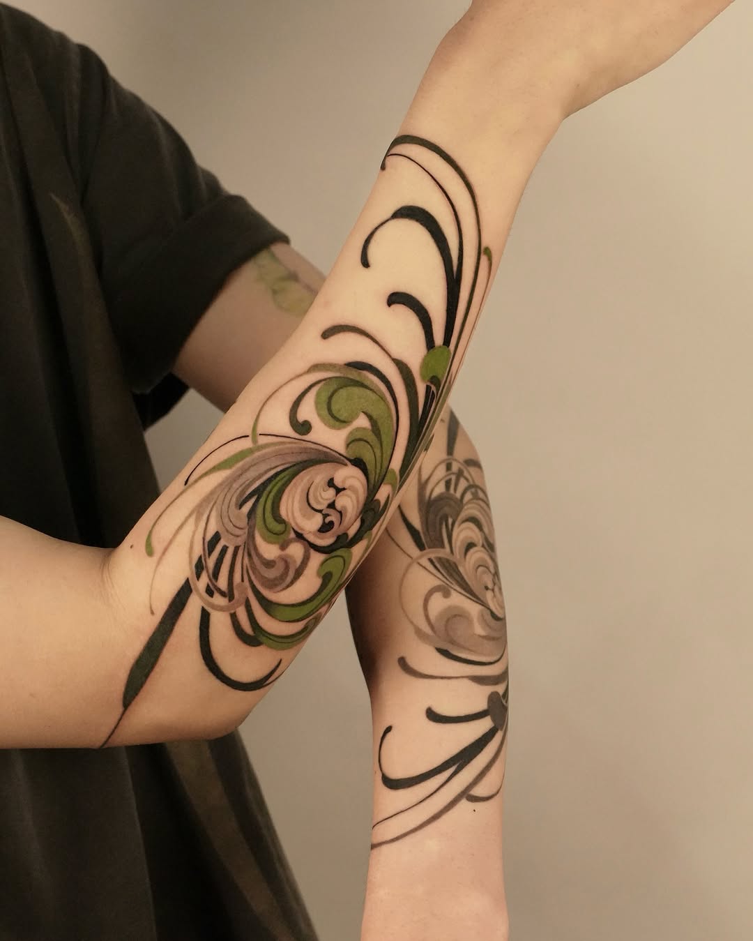 Elegant spiral flower tattoos on forearm