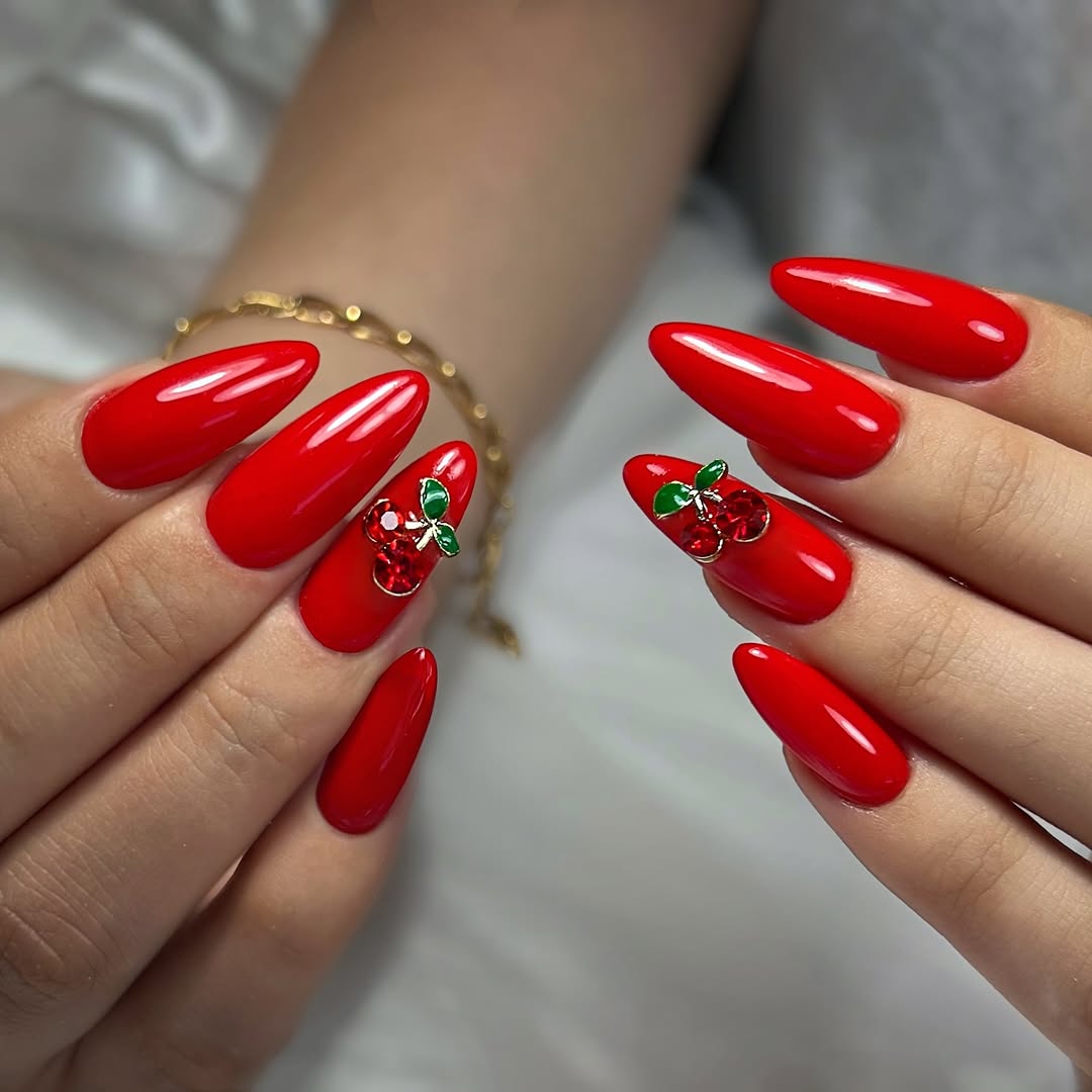 Stylish red nails with charming cherry accents