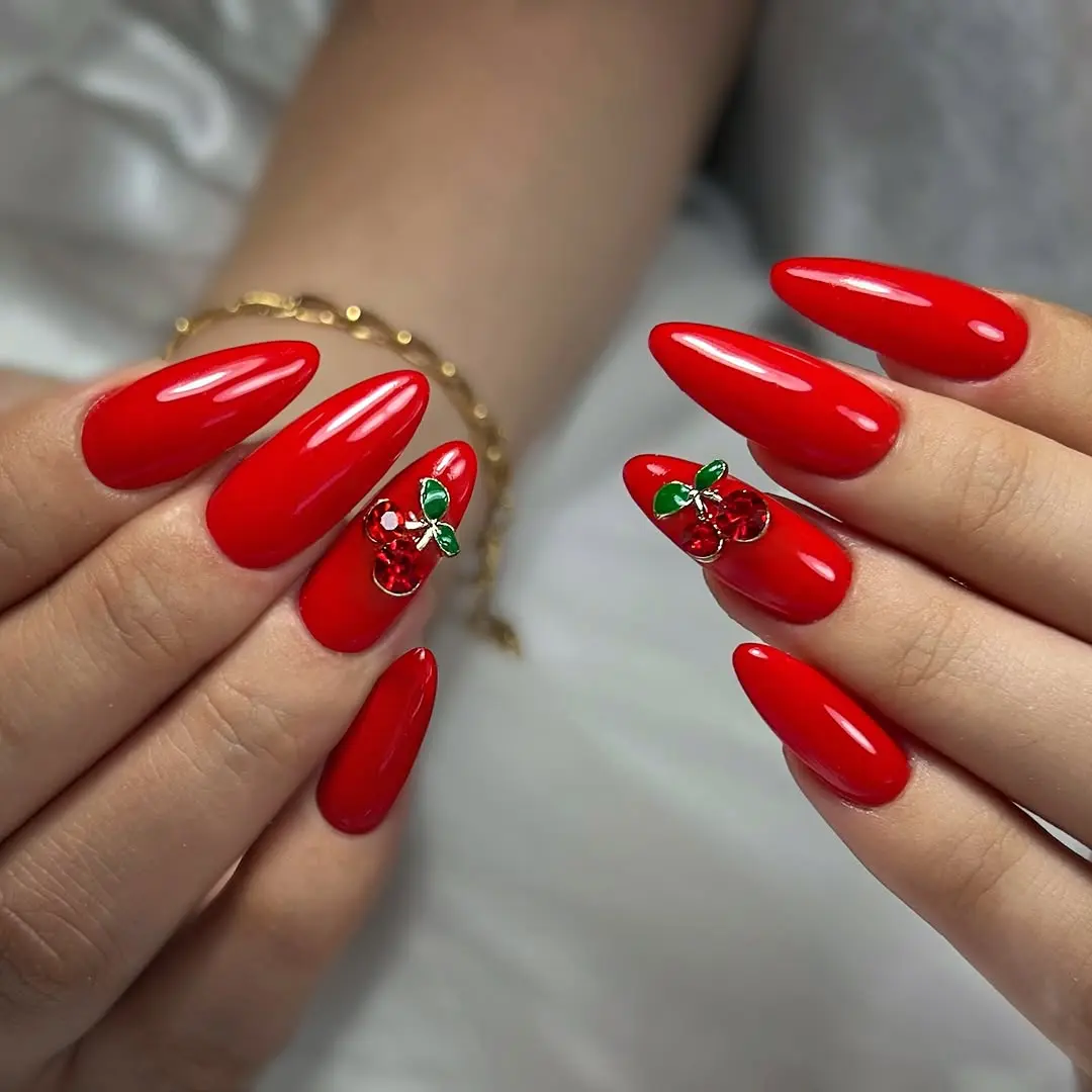 Stylish red nails with charming cherry accents