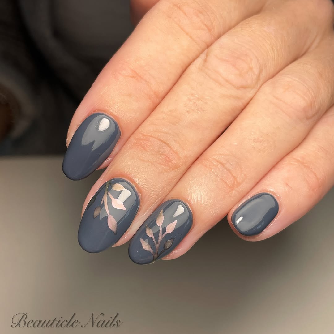 Stylish grey nails with delicate leaf art