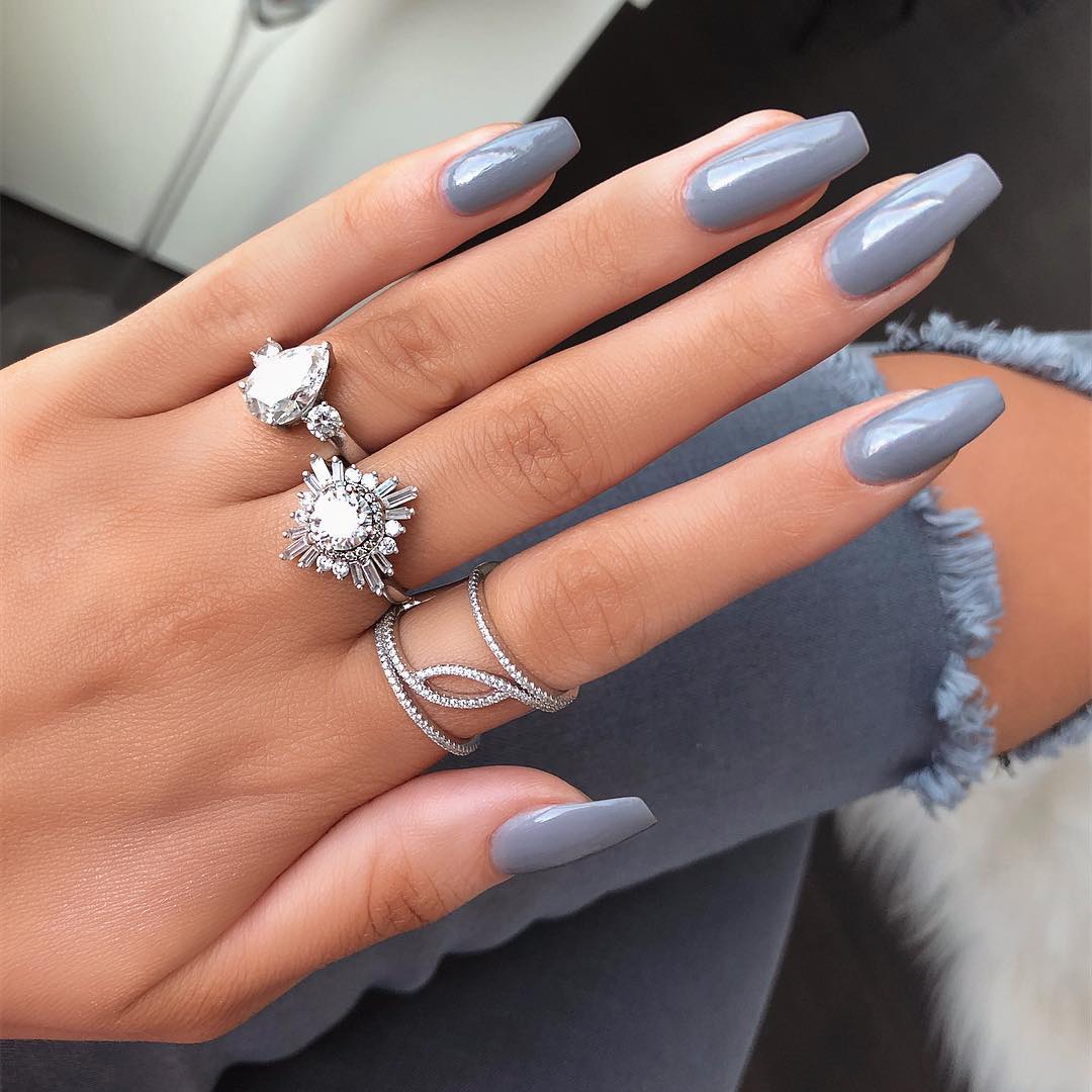 Chic grey nails adorned with stunning rings