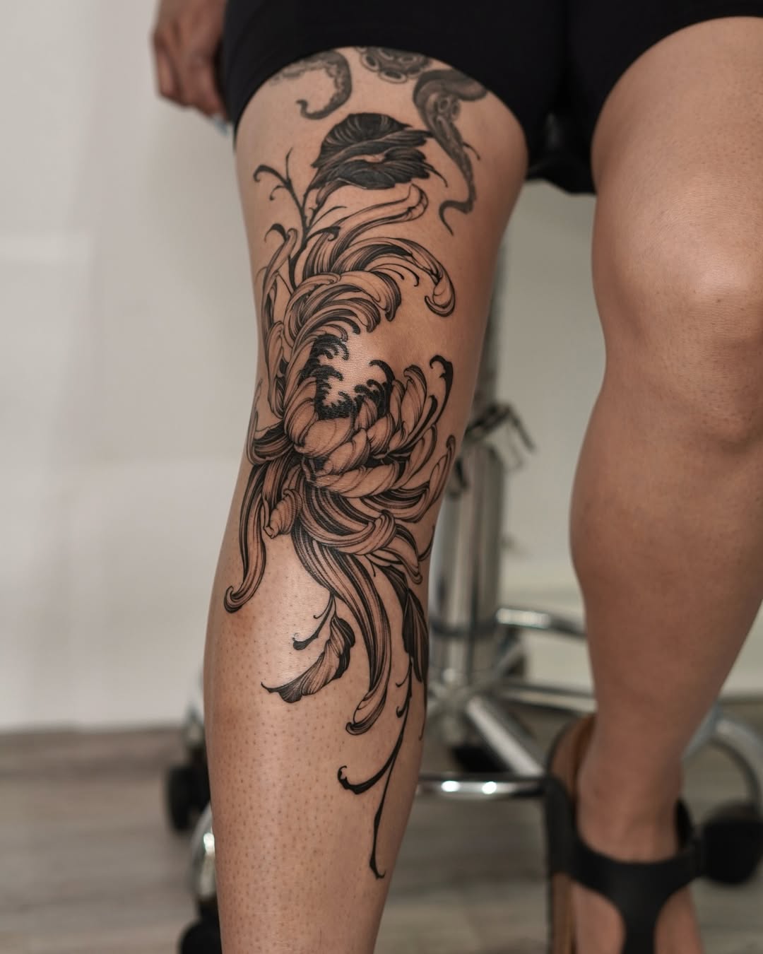 Elegant floral knee tattoo with intricate details