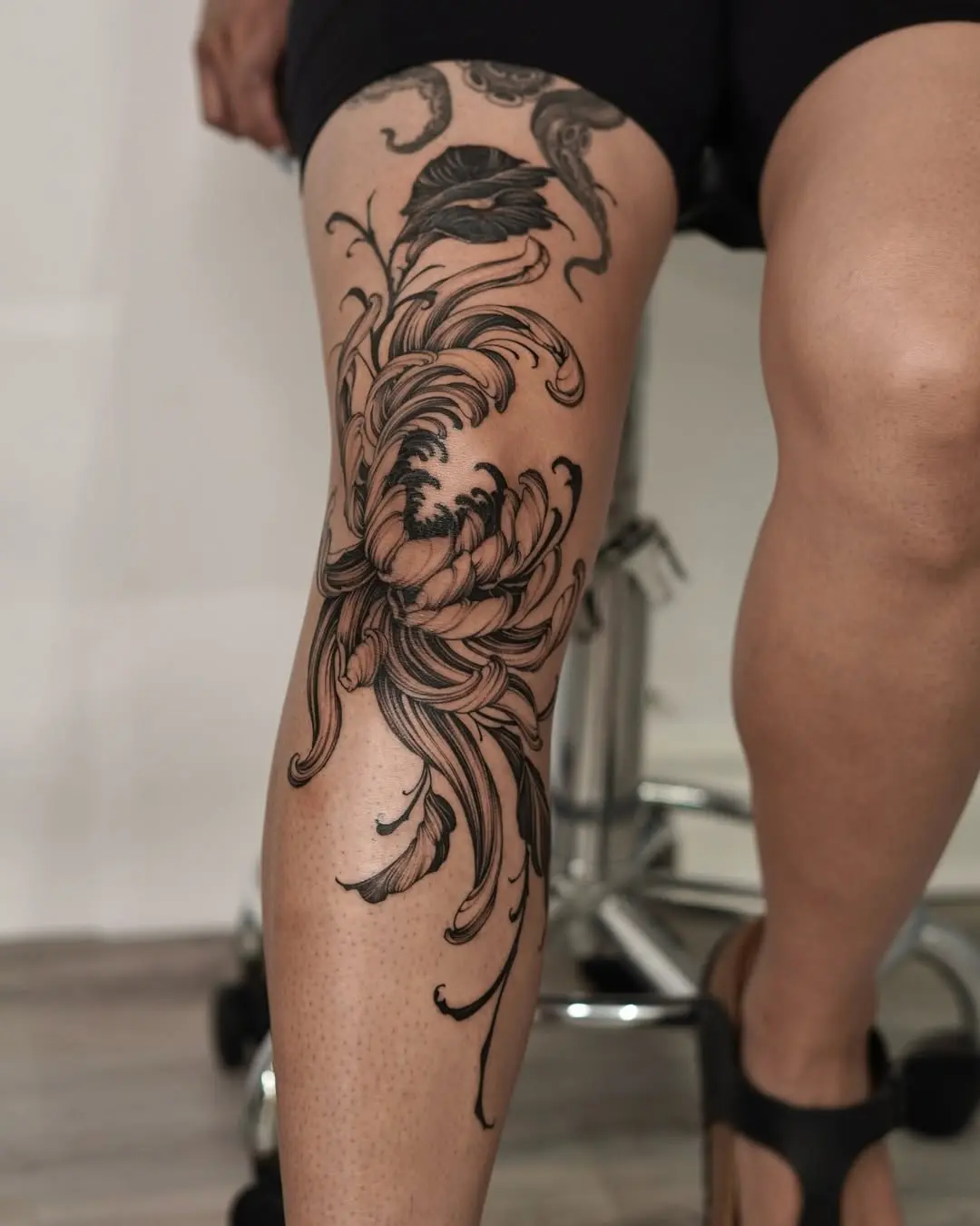 Elegant floral knee tattoo with intricate details