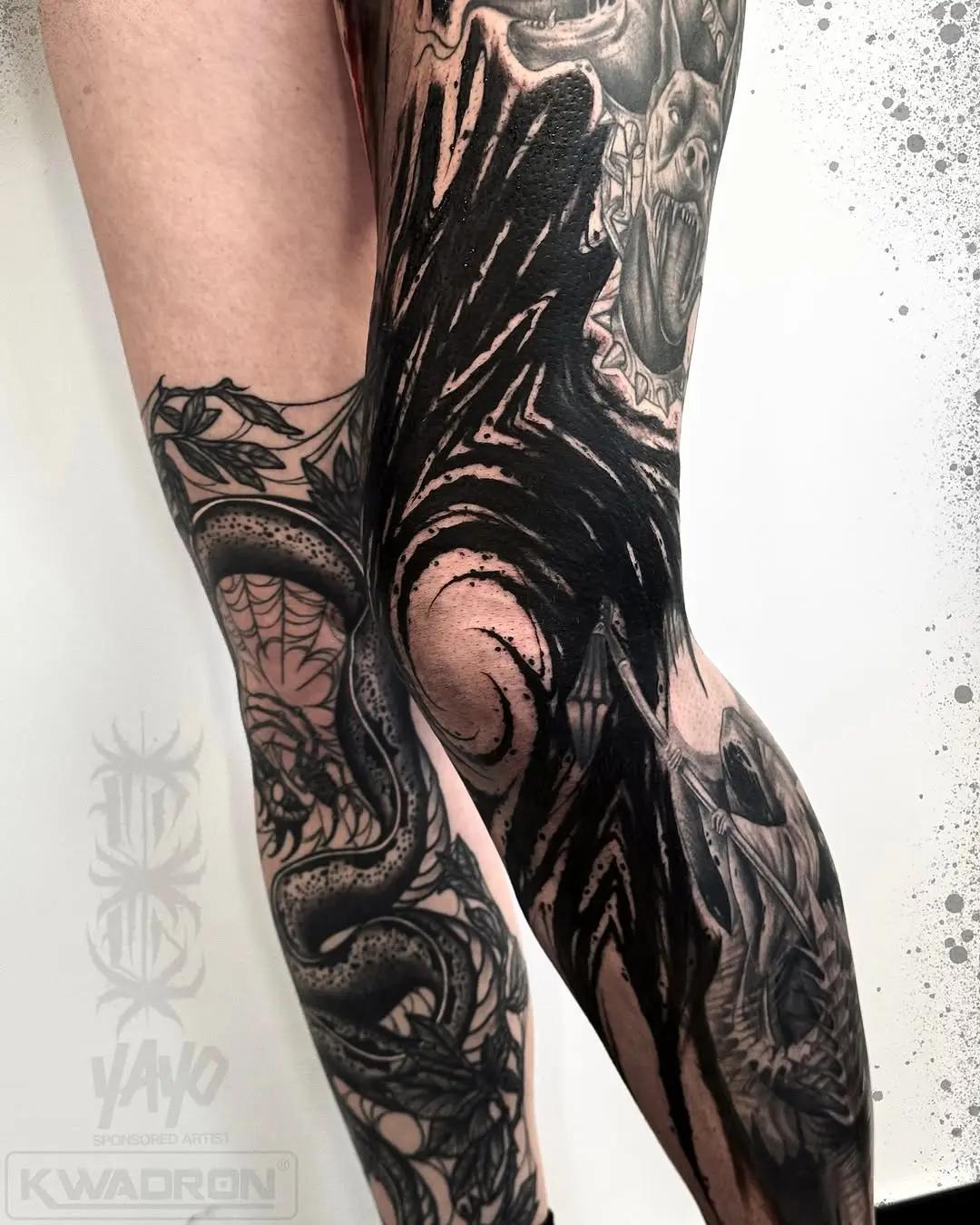 Striking knee tattoos with black and gray designs