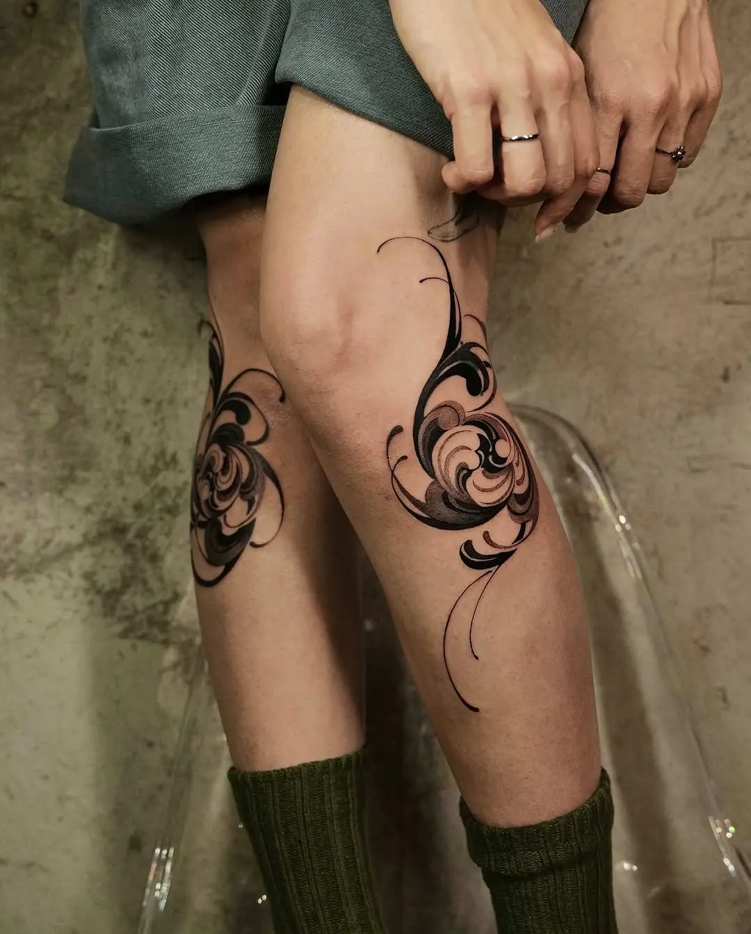 Elegant floral knee tattoo design with swirls