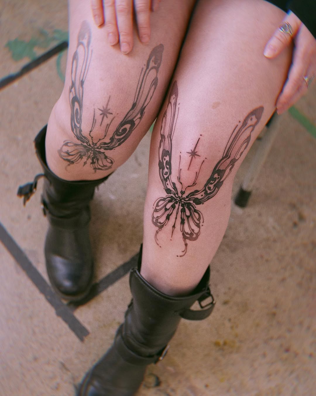 Elegant butterfly tattoos gracefully adorn the knees
