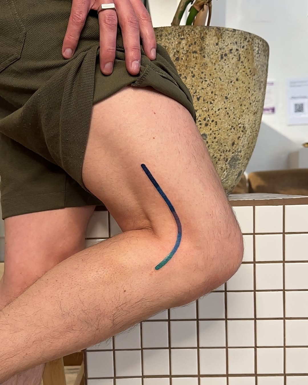 Minimalist leg tattoo with vibrant colors