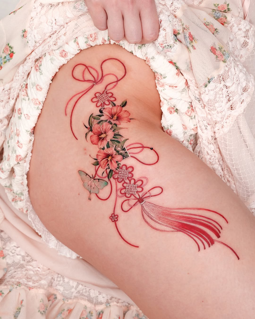 Elegant floral tattoo with butterfly and ribbons