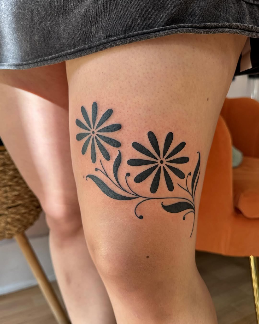 Bold floral leg tattoo adding nature's touch