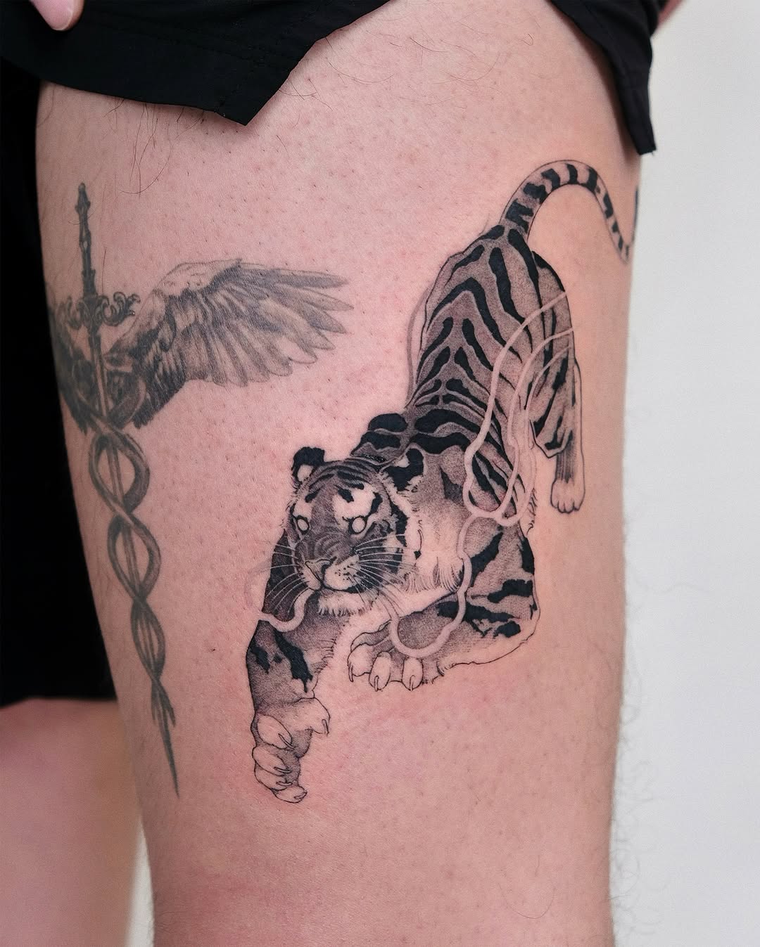 Expressive leg tattoo of a fierce tiger
