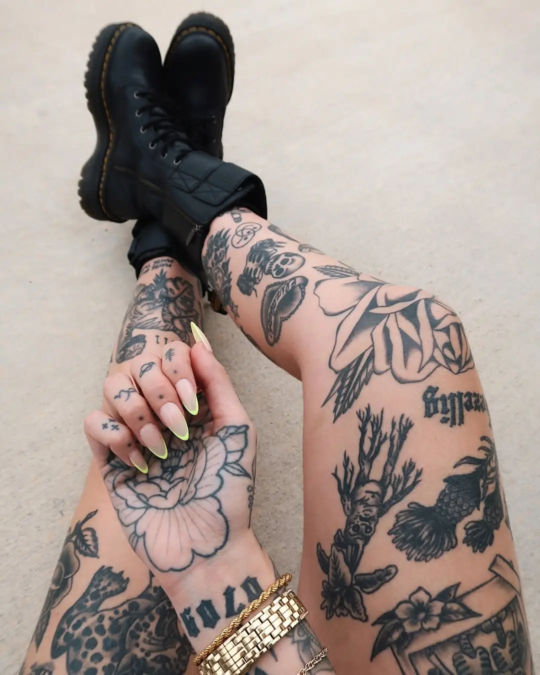Bold leg tattoos with striking designs and boots