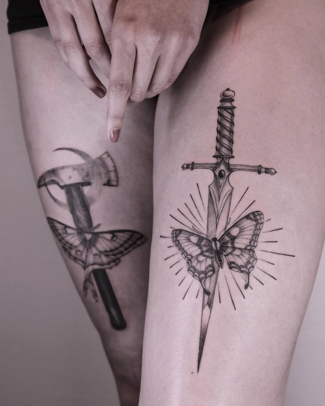 Intricate leg tattoos blending nature and weaponry