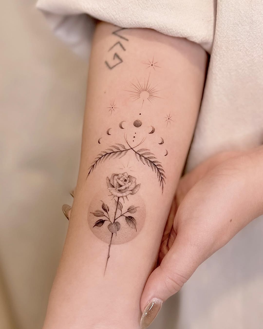 Elegant floral tattoo with celestial elements