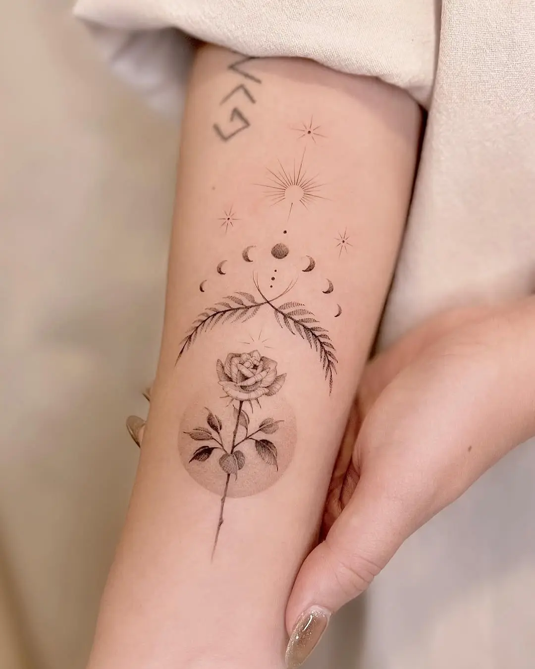 Elegant floral tattoo with celestial elements