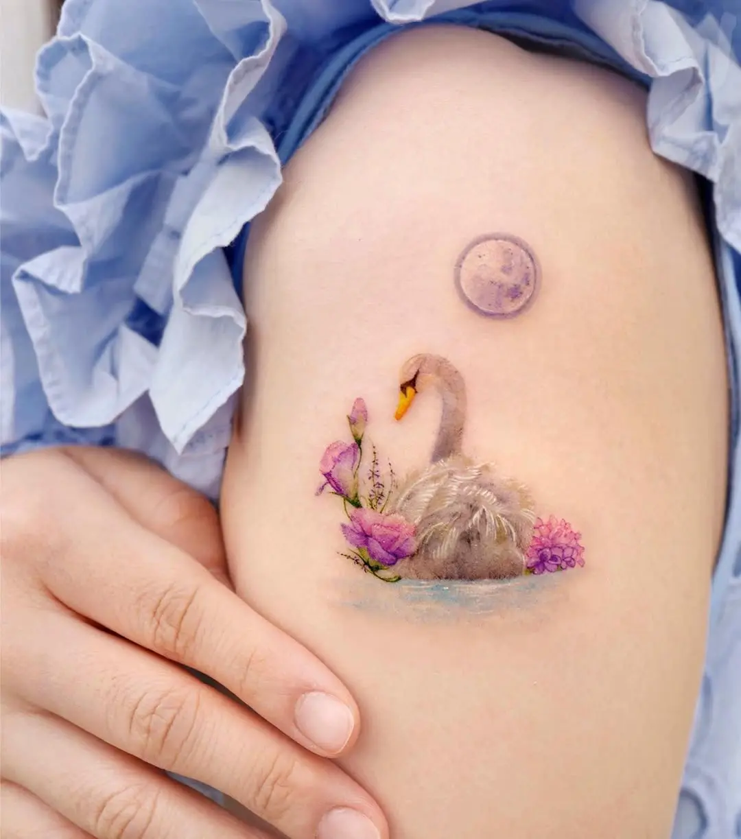 Elegant swan tattoo with floral details