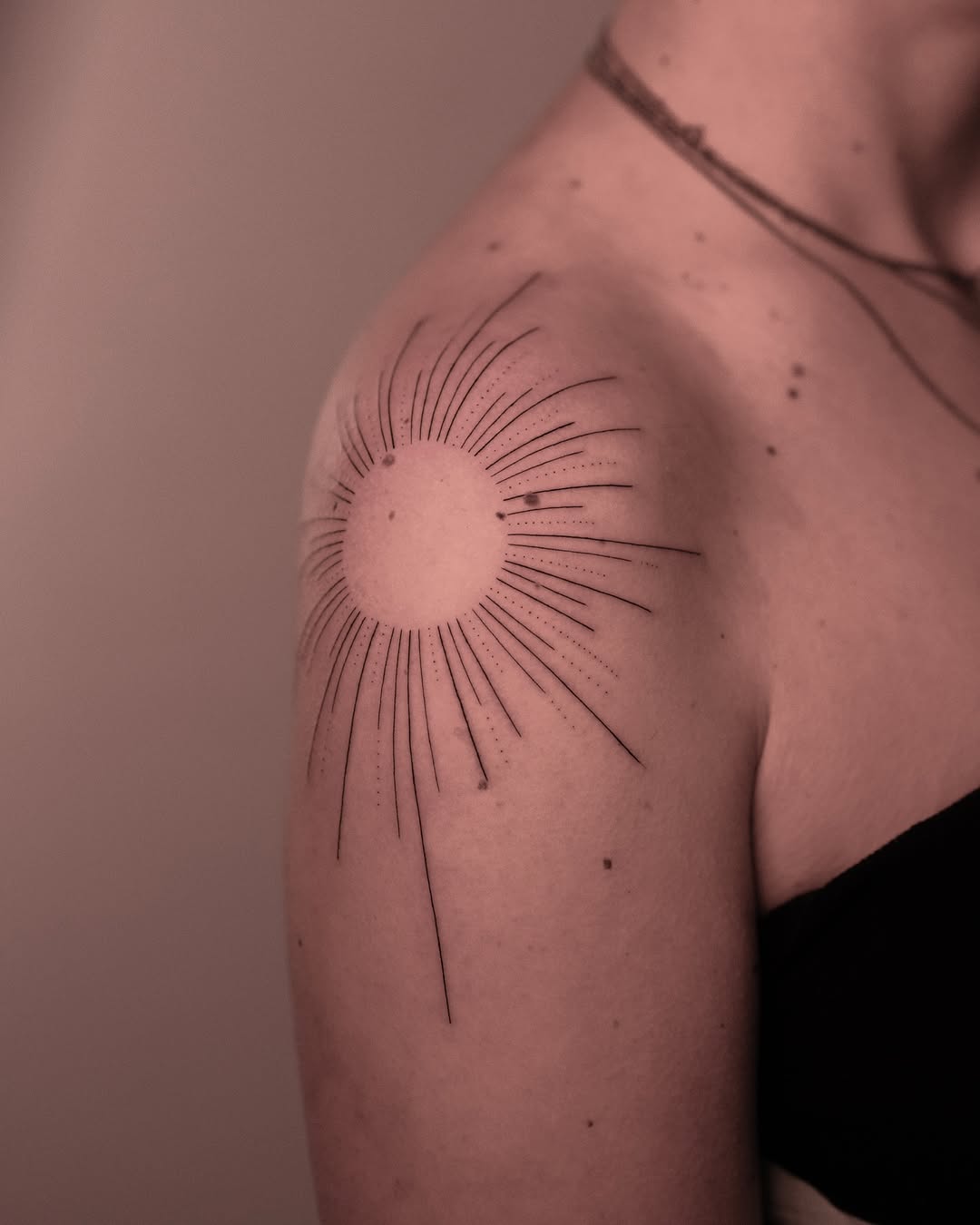 Minimalist sunburst design on shoulder