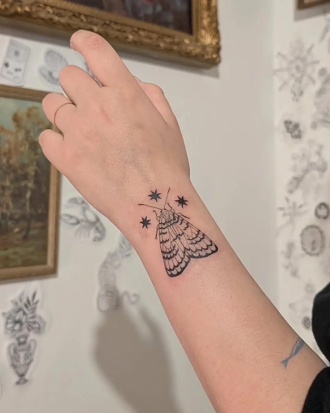 Intricate moth tattoo with starry accents