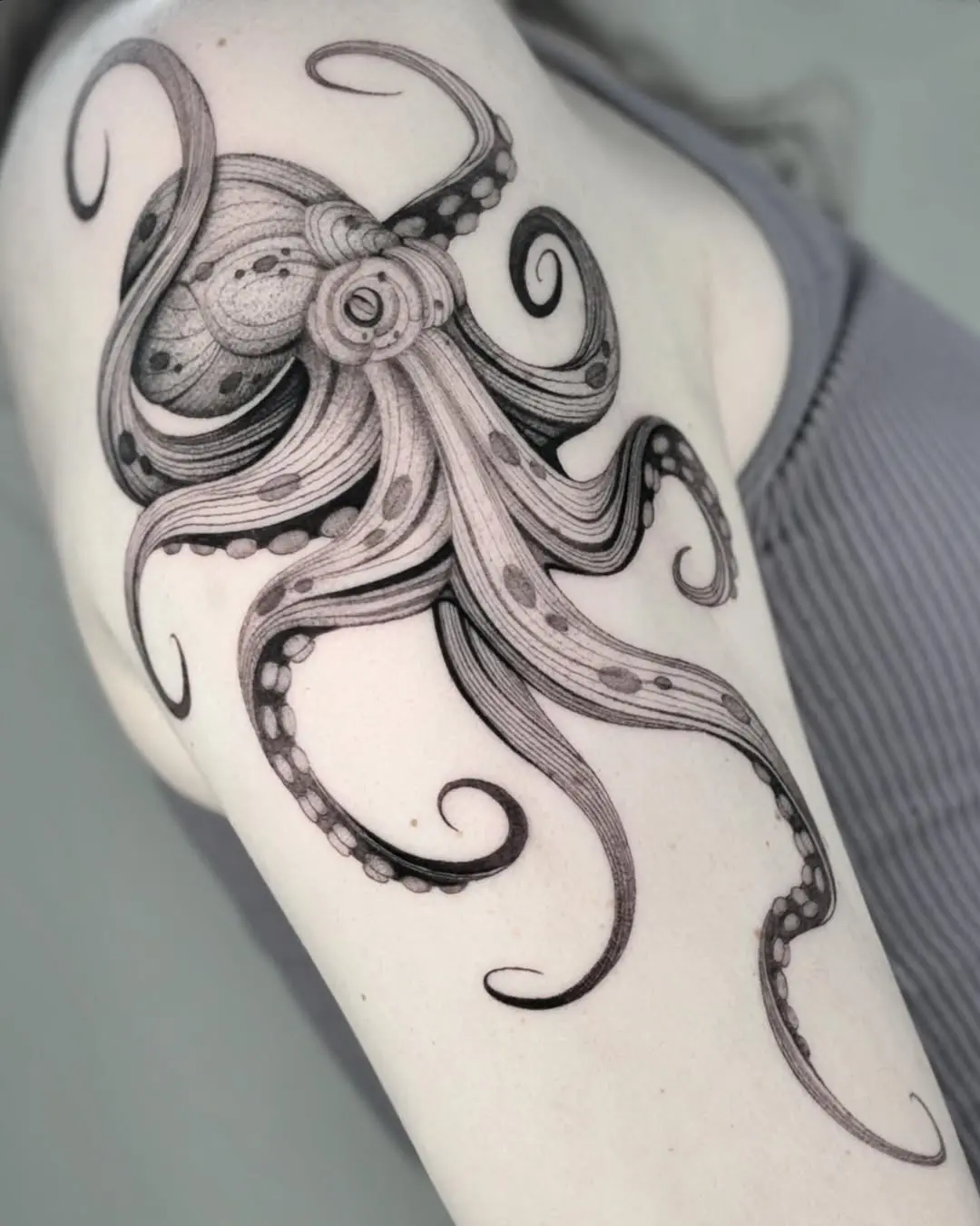 Intricate black ink octopus tattoo on arm