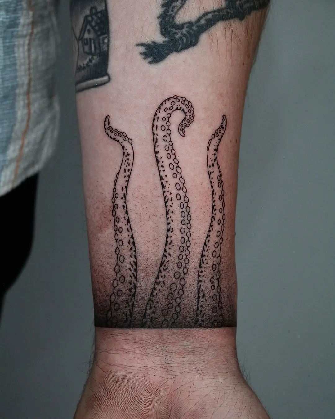 Stunning octopus tentacles tattoo on forearm