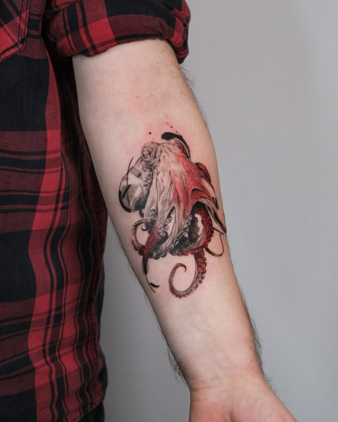 Stunning octopus tattoo with vibrant red details