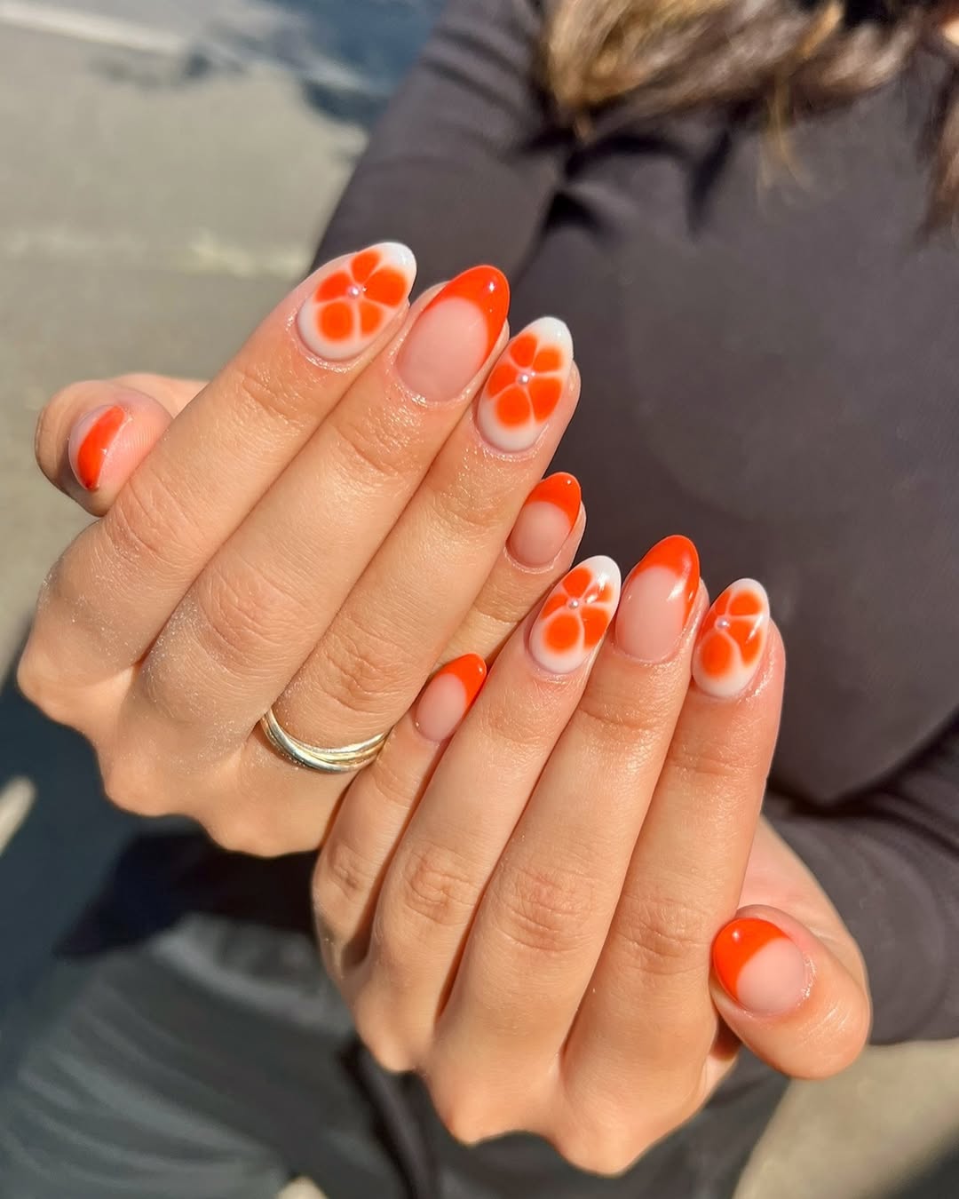 Chic orange floral nails for a vibrant look