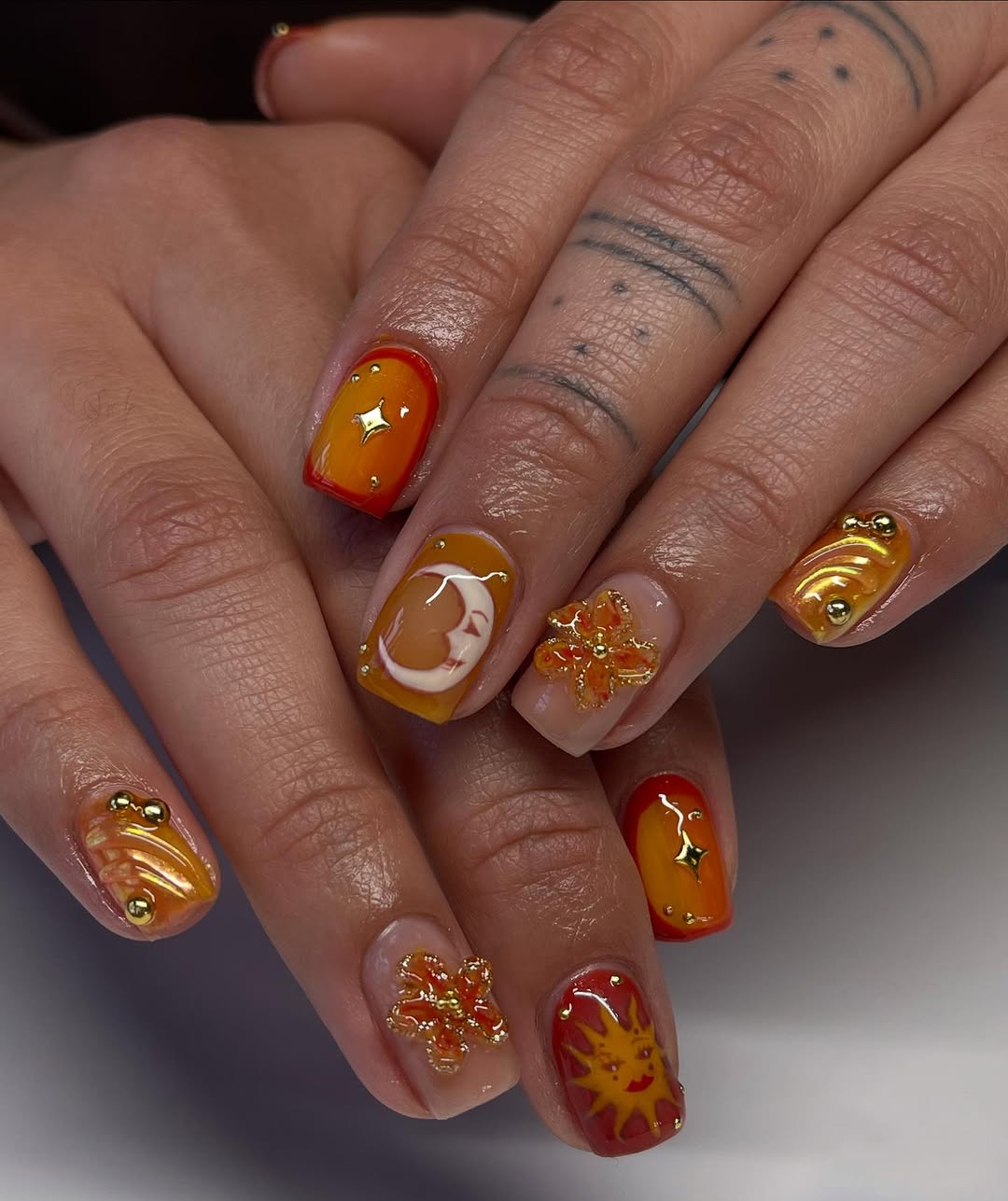 Vibrant orange sunset-inspired nail art design