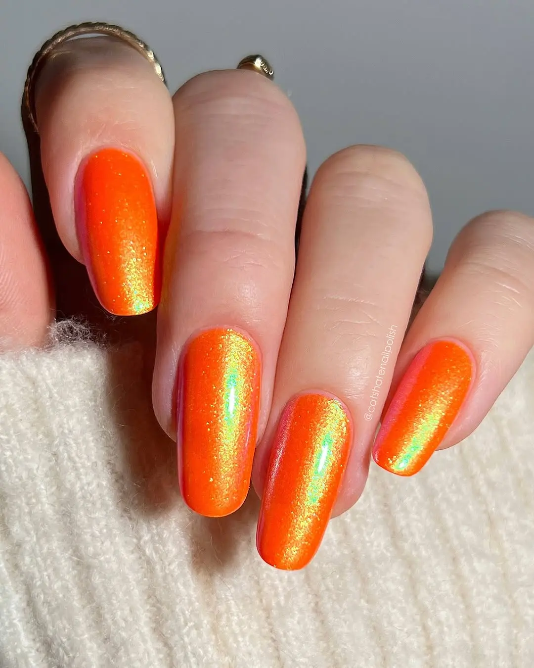 Vibrant orange nails with a stunning shimmer