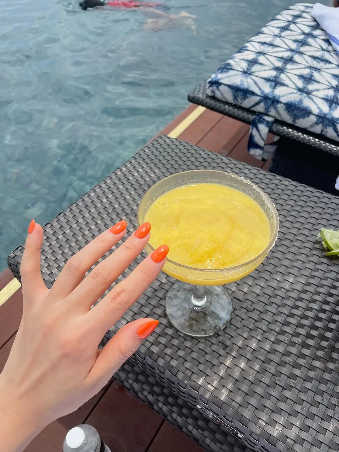 Vibrant orange nails complement summer vibes