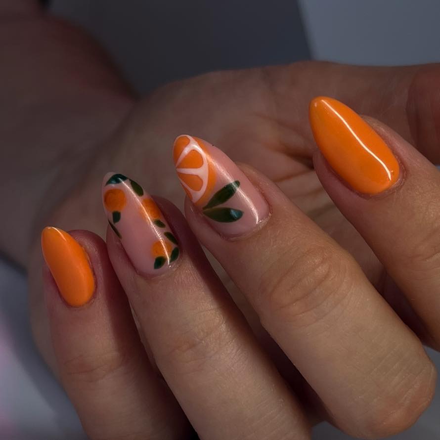 Vibrant Orange Nails with Floral Accents