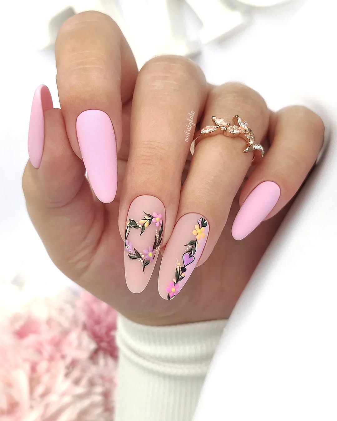 Chic pink nails adorned with floral art