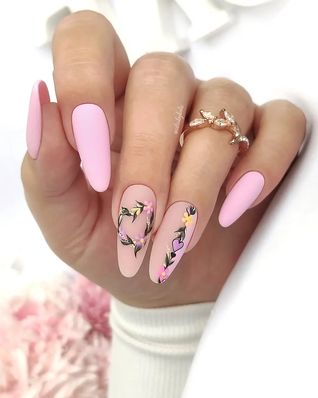 Chic pink nails adorned with floral art
