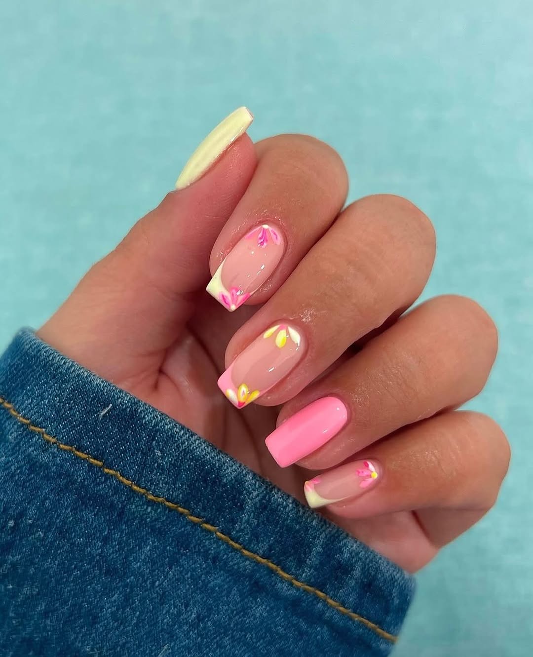 Chic pastel pink nails with floral accents