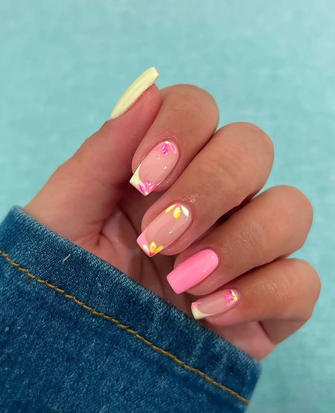 Chic pastel pink nails with floral accents