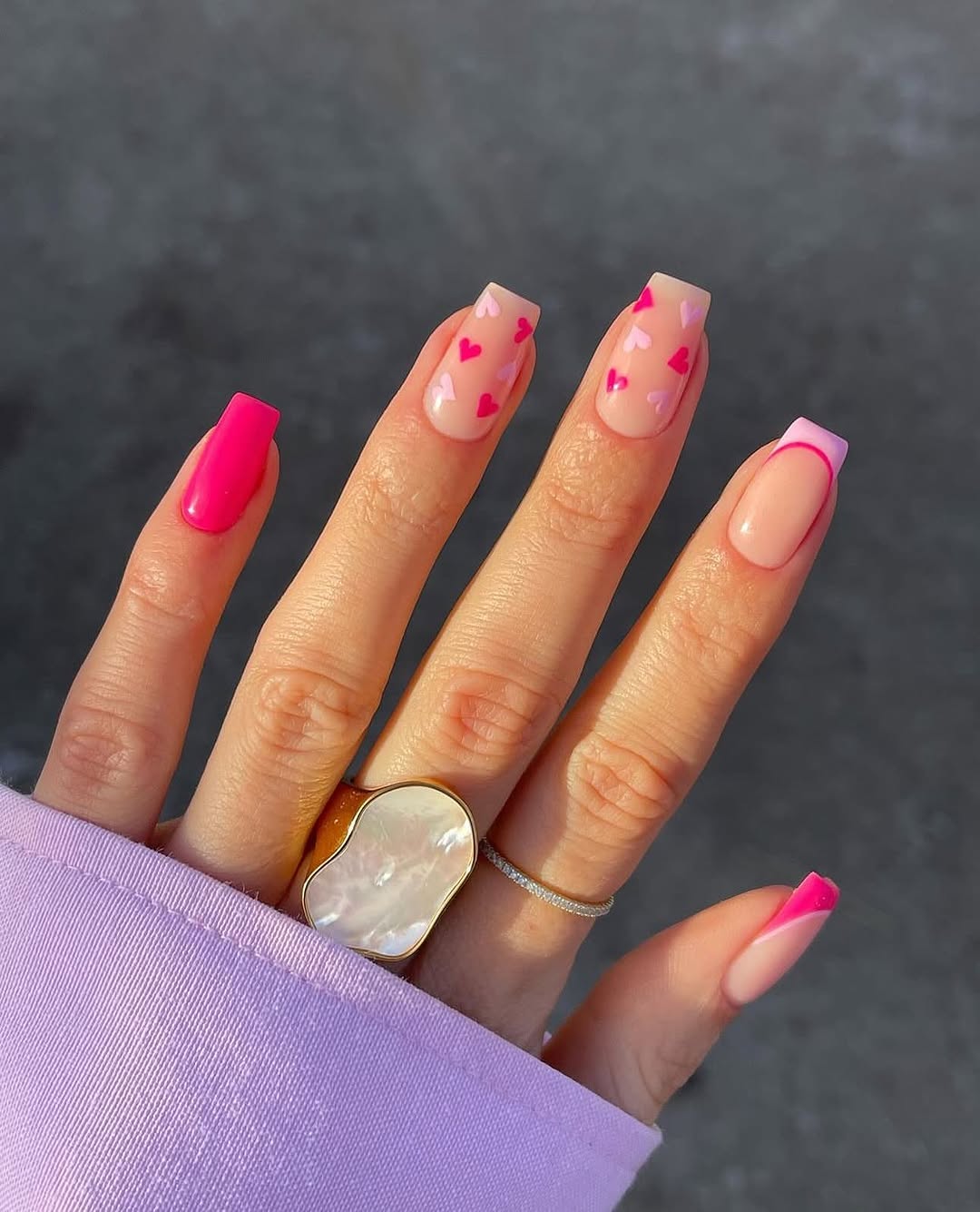 Charming pink nails with playful heart designs