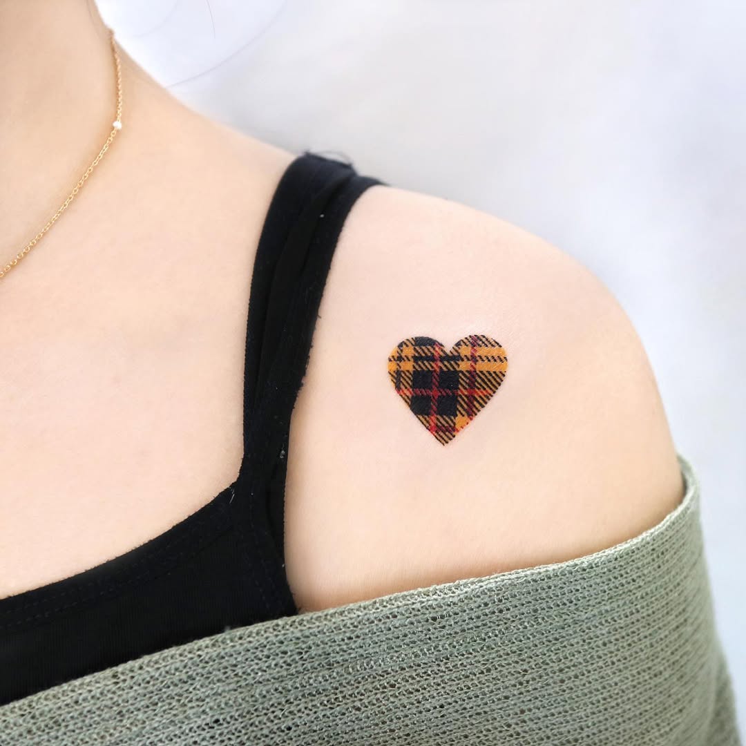 Charming plaid heart tattoo on shoulder