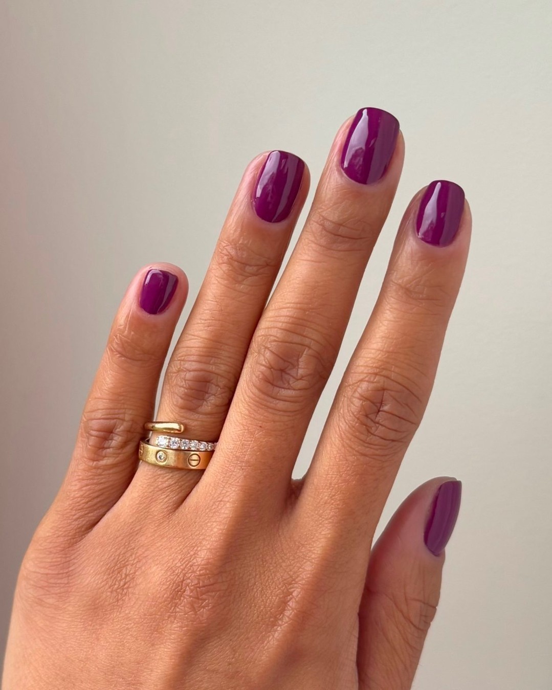 Chic purple nail design with elegant rings