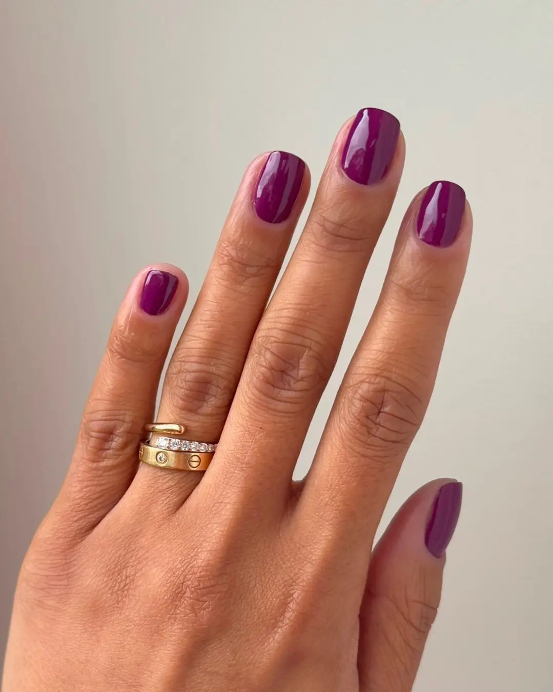 Chic purple nail design with elegant rings
