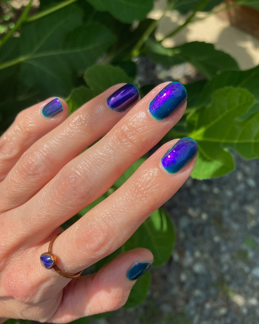 Vibrant purple nails with shimmering accents