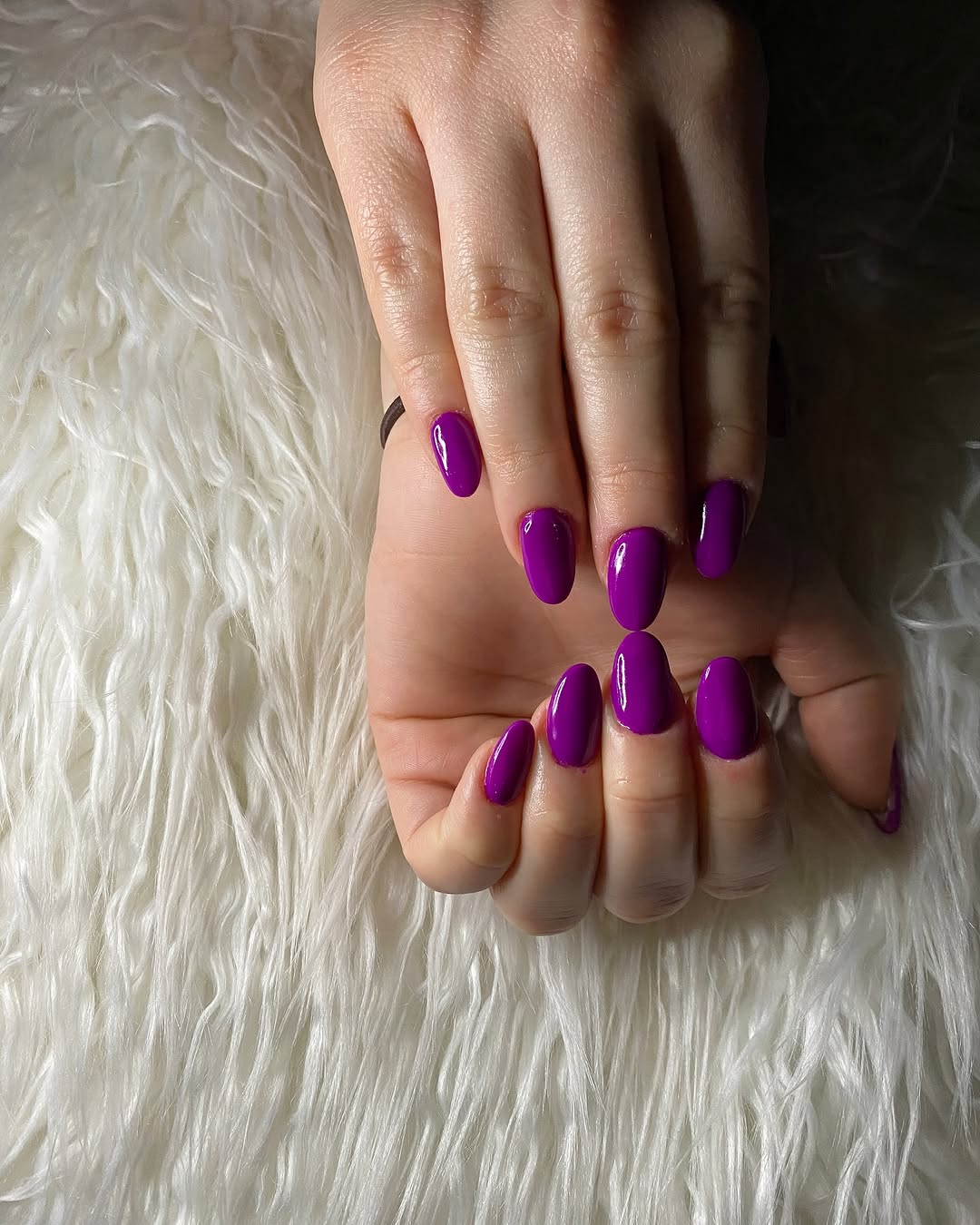Vibrant glossy purple nails for bold style