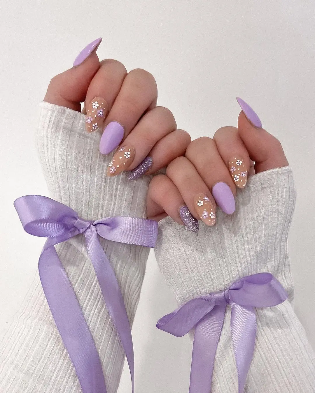 Chic purple nails with floral accents and bows