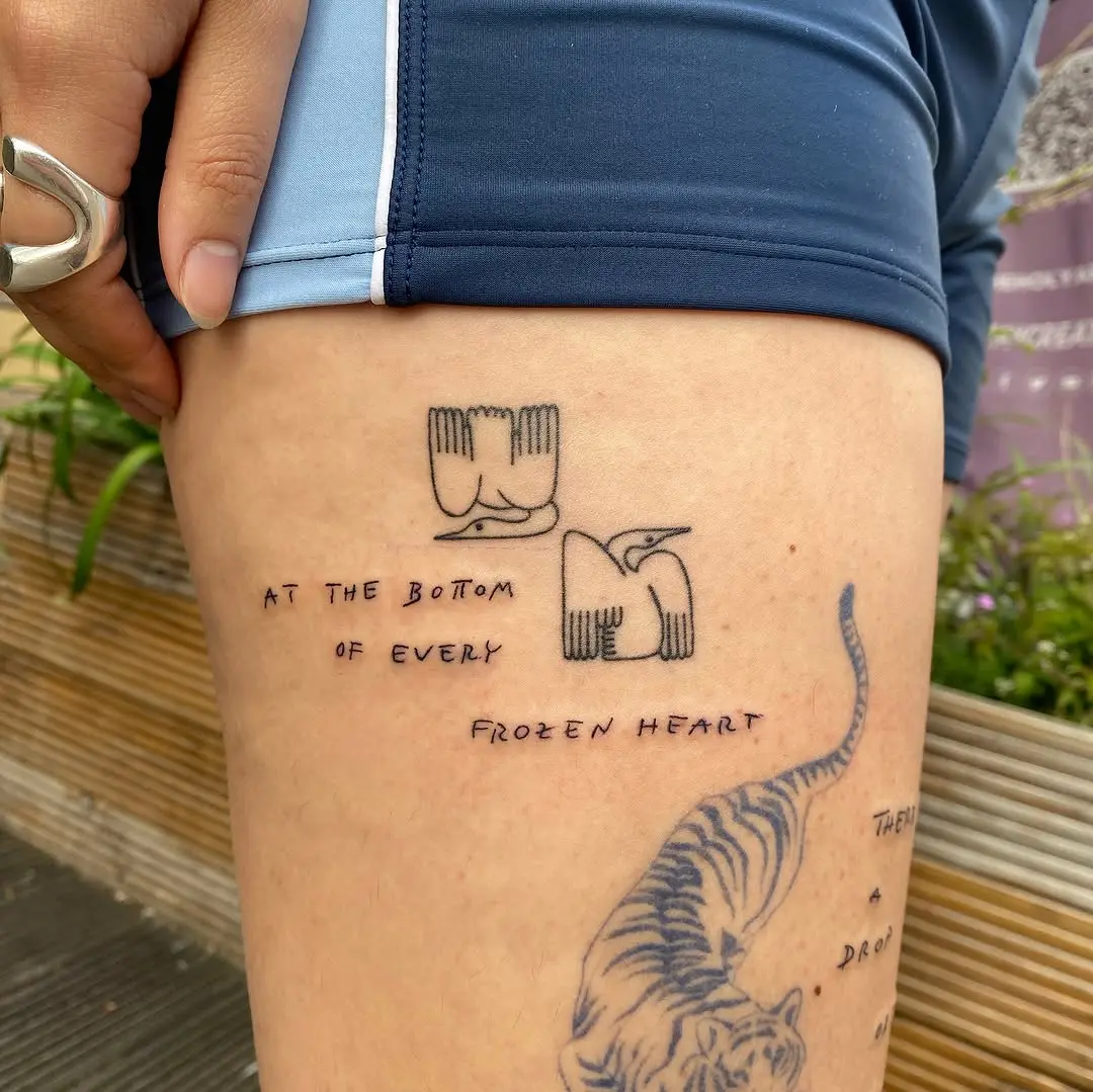 Minimalist quote tattoo on thigh