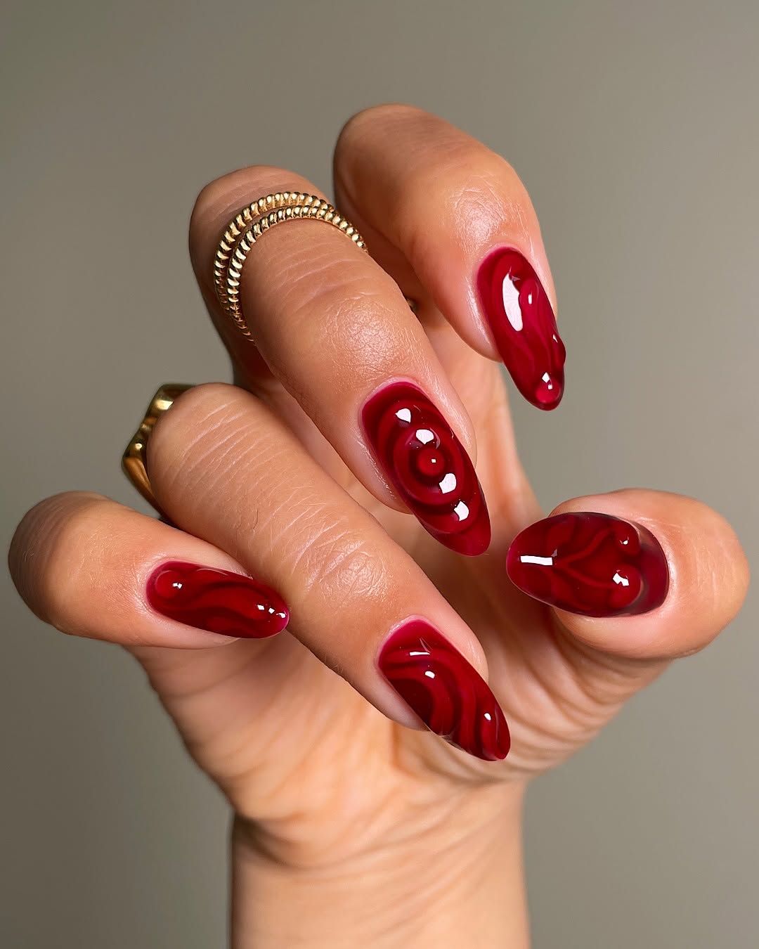 Bold Red Nails with Unique Swirl Details