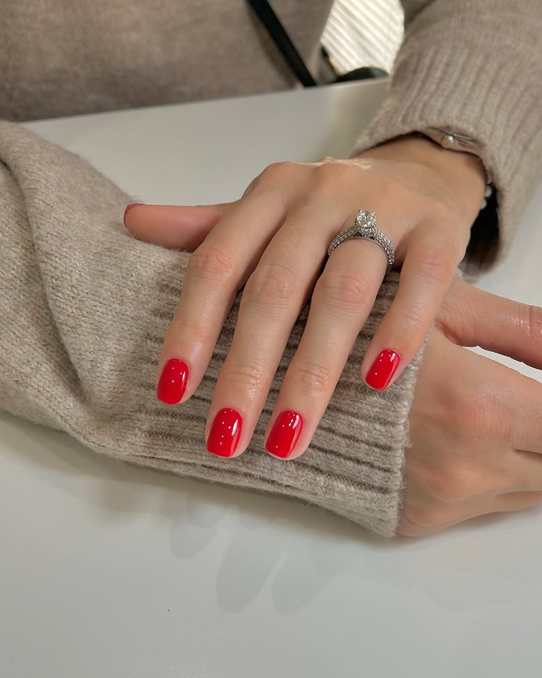 Chic red nails with a touch of elegance