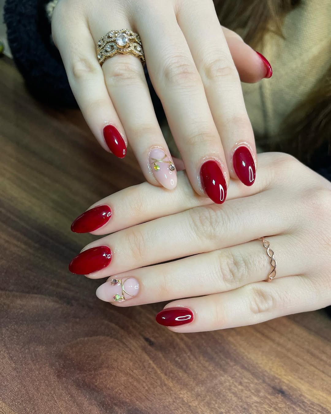 Elegant red nails with chic gold accents
