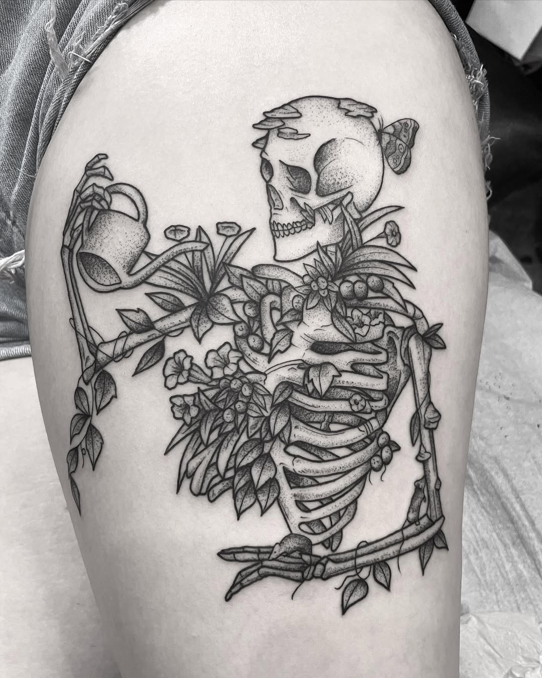 Whimsical skeleton tattoo with floral elements