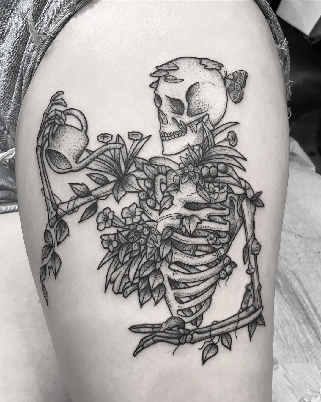 Whimsical skeleton tattoo with floral elements