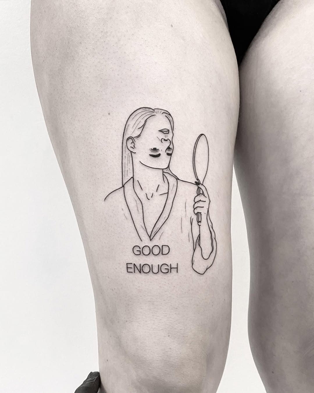 Empowering self-love tattoo with mirror reflection